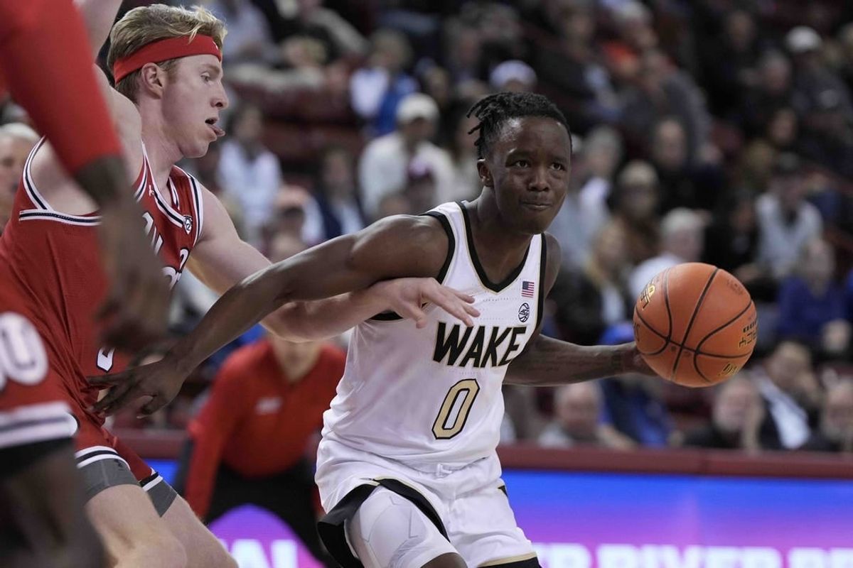 Nov 16, 2023; Charleston, South Carolina, USA; Wake Forest Demon Deacons guard Kevin Miller (0) drives the ball against the Utah Utes in the first half at TD Arena.