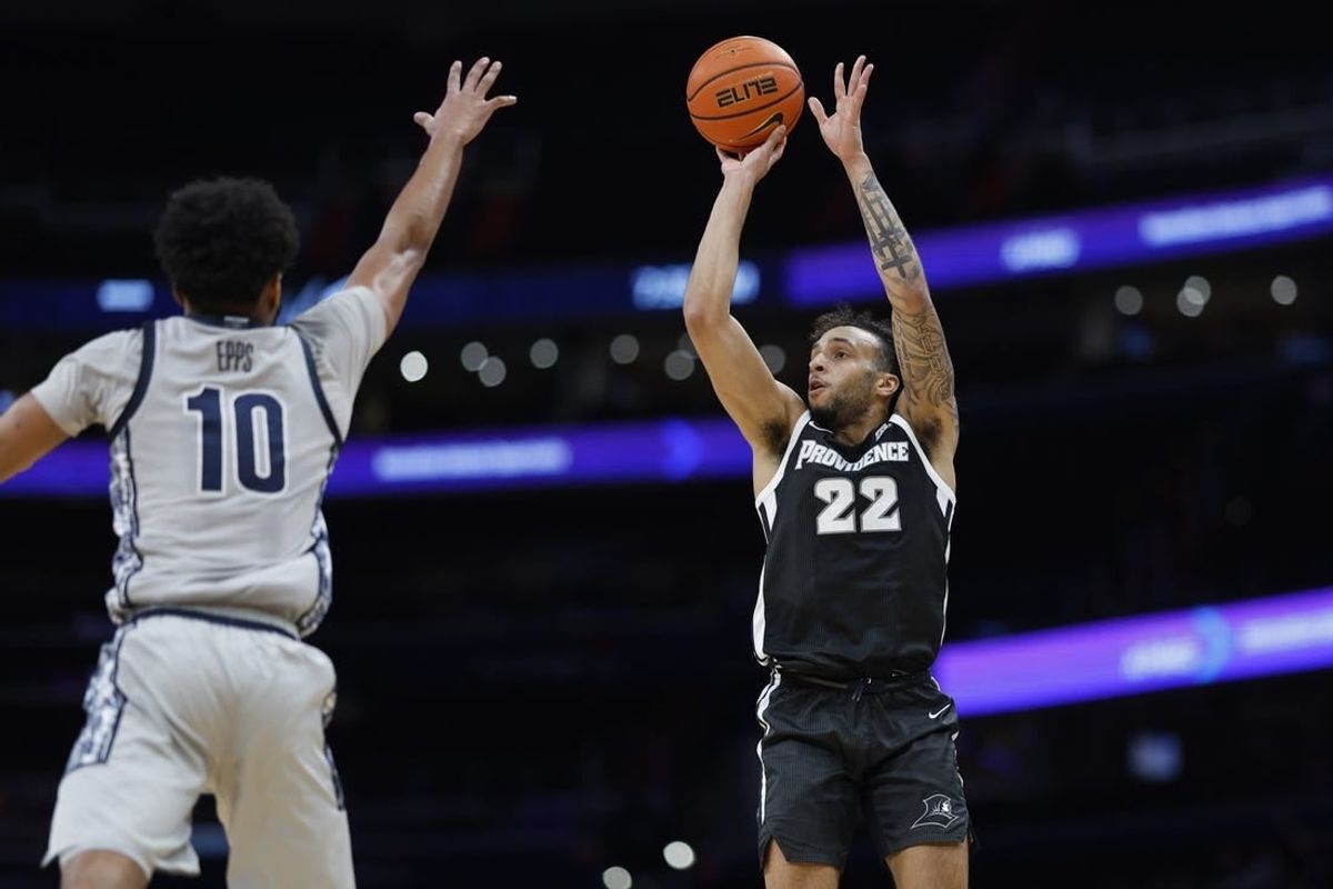 Mar 5, 2024; Washington, District of Columbia, USA;Providence Friars guard Devin Carter (22) shoots the ball as Georgetown Hoyas guard Jayden Epps (10) defends in the first half  at Capital One Arena.