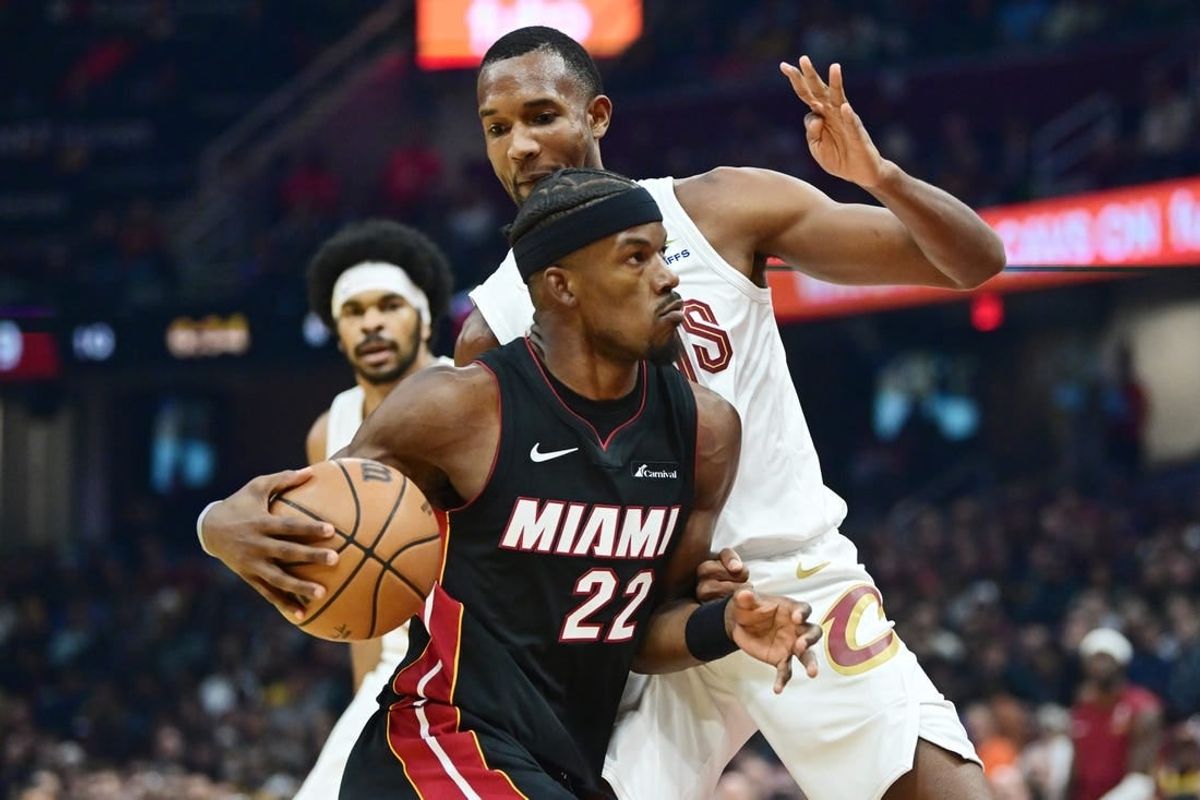 Nov 22, 2023; Cleveland, Ohio, USA; Miami Heat forward Jimmy Butler (22) drives to the basket against Cleveland Cavaliers forward Evan Mobley (4) during the first quarter at Rocket Mortgage FieldHouse.