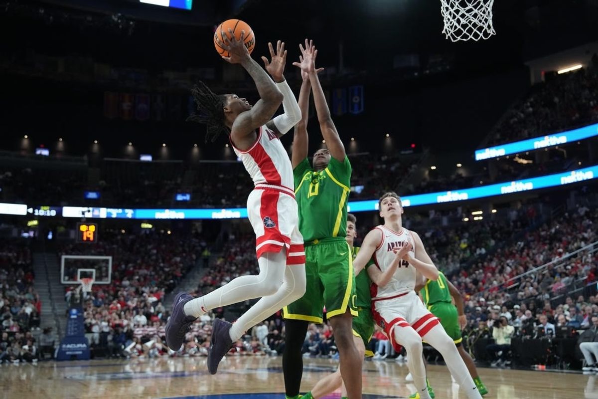Mar 15, 2024; Las Vegas, NV, USA; Arizona Wildcats guard Caleb Love (2) shoots the ball against Oregon Ducks forward Kwame Evans Jr. (10) in the first half at T-Mobile Arena.