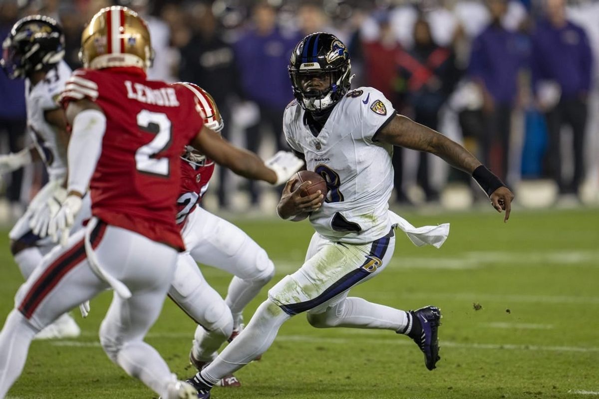 Dec 25, 2023; Santa Clara, California, USA; Baltimore Ravens quarterback Lamar Jackson (8) scrambles with the football against San Francisco 49ers safety Ji'Ayir Brown (27) during the second quarter at Levi's Stadium.