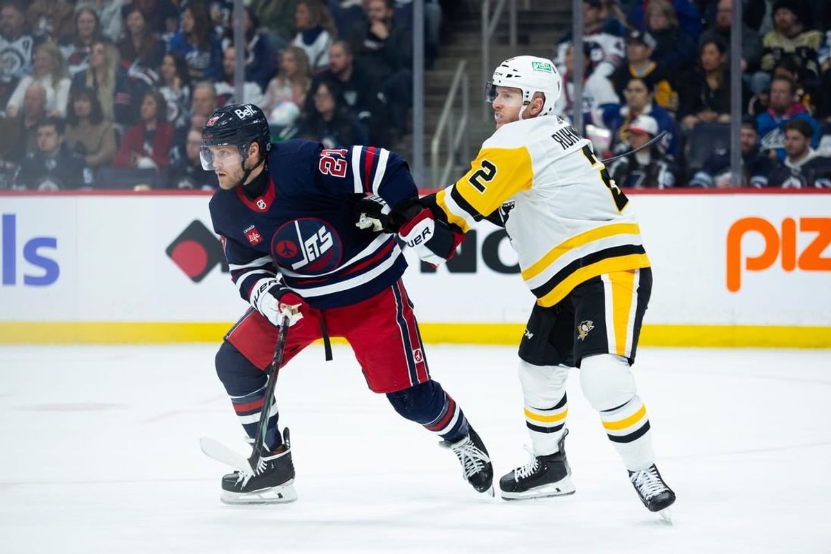 Feb 10, 2024; Winnipeg, Manitoba, CAN;  Pittsburgh Penguins defenseman Chad Ruhwedel (2) jostles for position with Winnipeg Jets forward Nikolaj Ehlers (27) during the second period at Canada Life Centre.