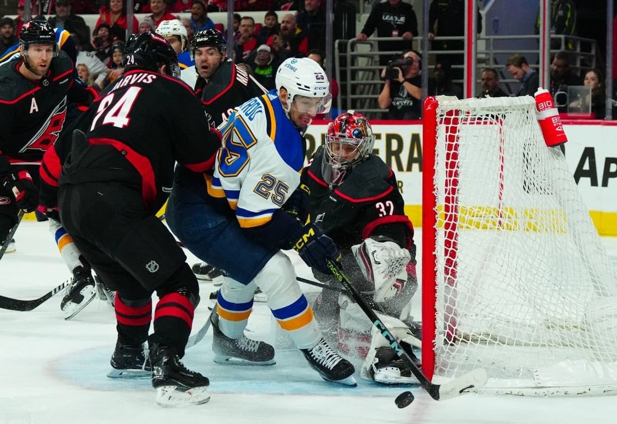 Jan 6, 2024; Raleigh, North Carolina, USA; Carolina Hurricanes goaltender Antti Raanta (32) stops the shot attempt by St. Louis Blues center Jordan Kyrou (25) during the second period at PNC Arena.