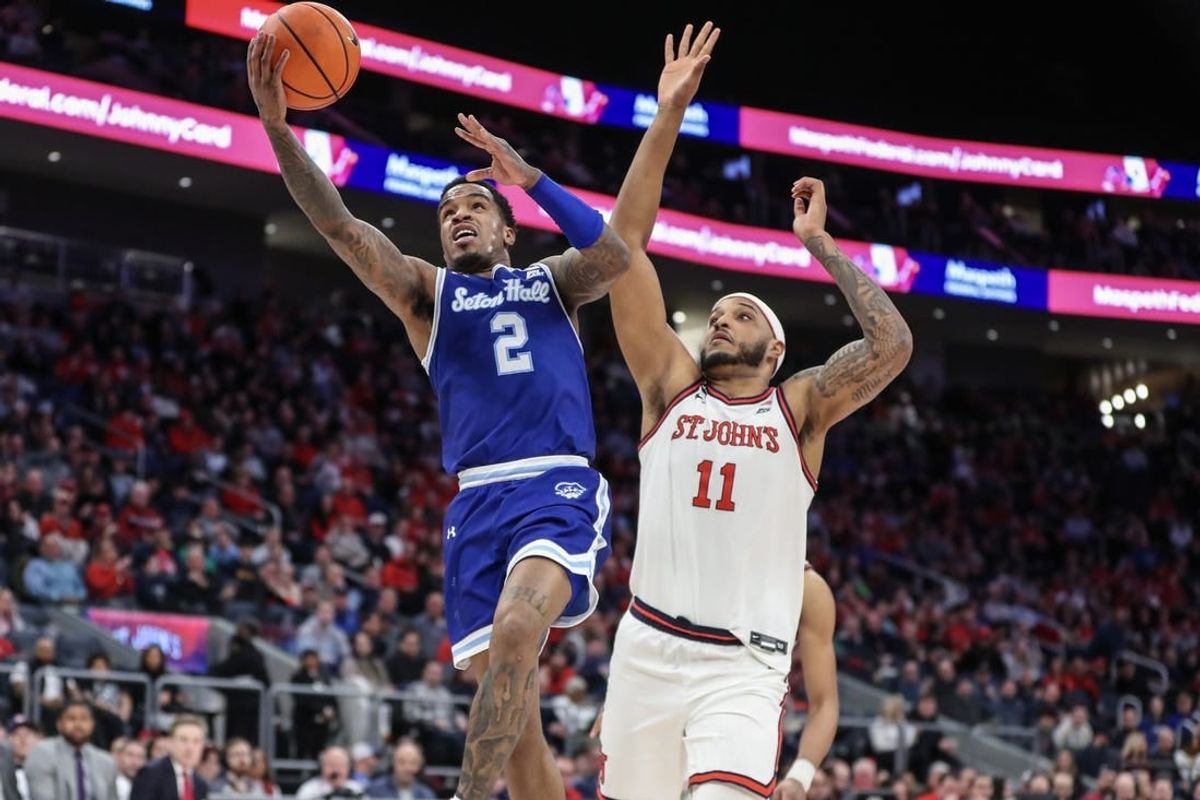 Feb 18, 2024; Elmont, New York, USA;  Seton Hall Pirates guard Al-Amir Dawes (2) drives past St. John's Red Storm center Joel Soriano (11) in the first half at UBS Arena.