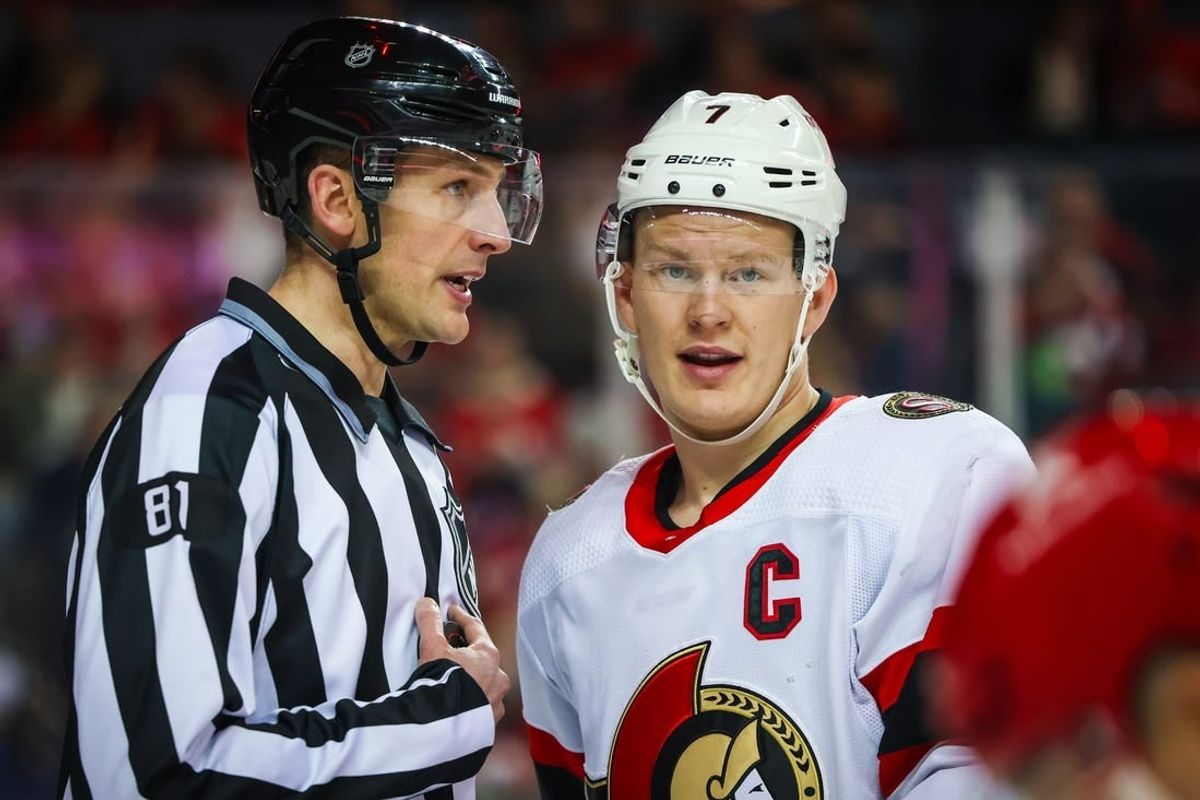 Jan 9, 2024; Calgary, Alberta, CAN; Ottawa Senators left wing Brady Tkachuk (7) and linesman Ryan Daisy (81) exchange words during the second period against the Calgary Flames at Scotiabank Saddledome.