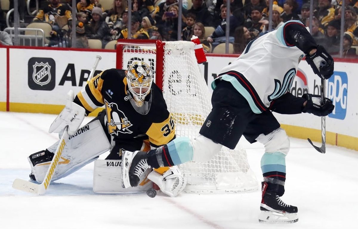 Jan 15, 2024; Pittsburgh, Pennsylvania, USA; Pittsburgh Penguins goaltender Tristan Jarry (35) makes a save against Seattle Kraken Jaden Schwartz (right) during the second period at PPG Paints Arena.