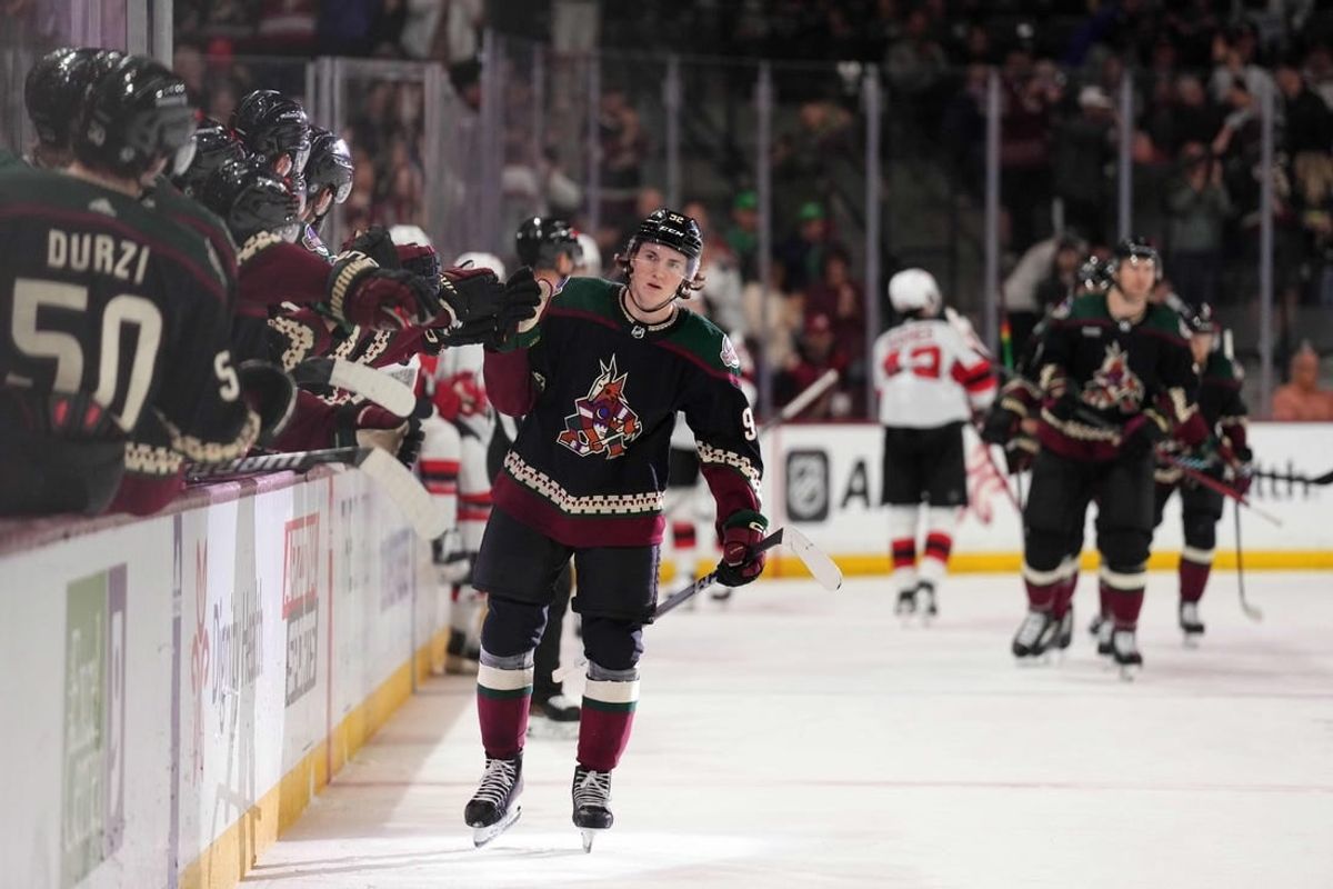 Mar 16, 2024; Tempe, Arizona, USA; Arizona Coyotes center Logan Cooley (92) celebrates his goal against the New Jersey Devils during the first period at Mullett Arena.