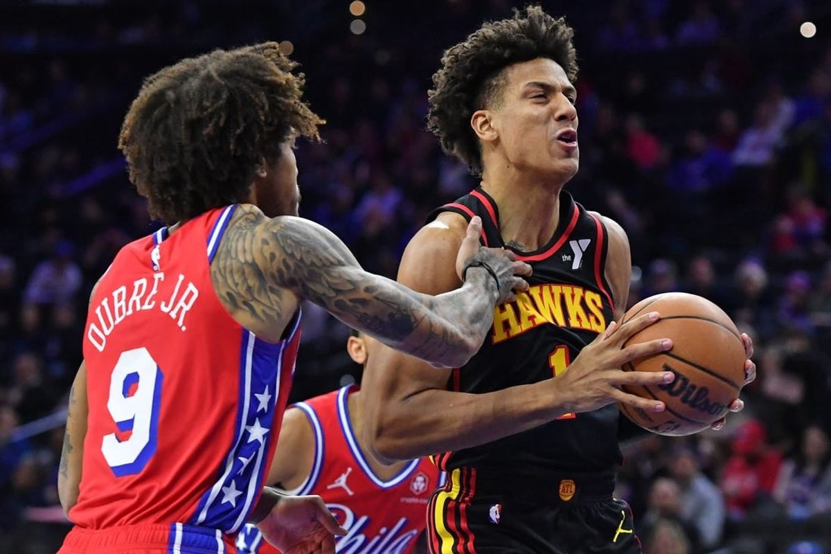 Feb 9, 2024; Philadelphia, Pennsylvania, USA; Atlanta Hawks forward Jalen Johnson (1) drives past Philadelphia 76ers guard Kelly Oubre Jr. (9) during the first quarter at Wells Fargo Center.