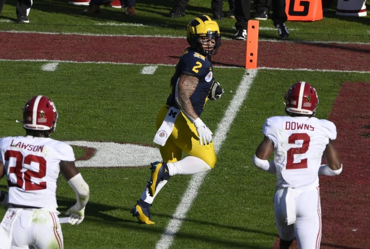 Jan 1, 2024; Pasadena, CA, USA; Michigan Wolverines running back Blake Corum (2) scores a touchdown past Alabama Crimson Tide linebacker Deontae Lawson (32) and defensive back Caleb Downs (2) in the 2nd quarter of the 2024 Rose Bowl college football playoff semifinal game at Rose Bowl.