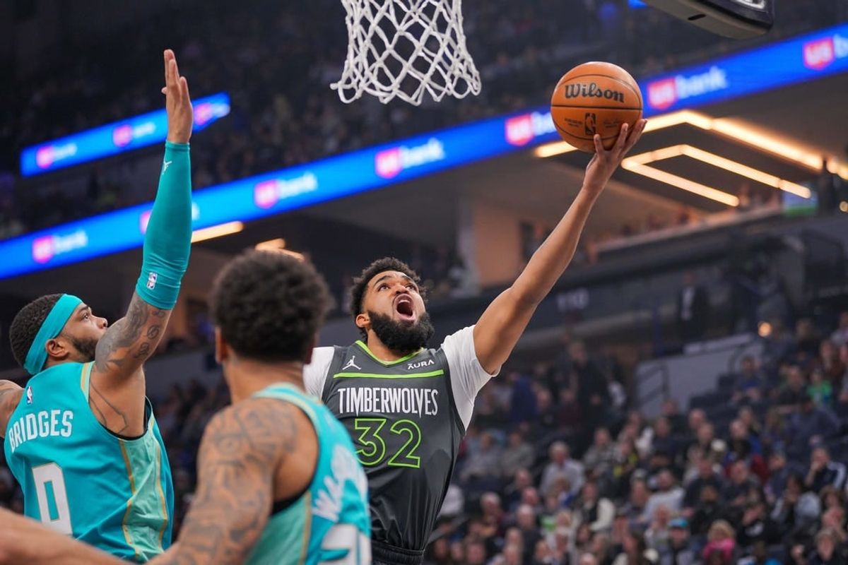Jan 22, 2024; Minneapolis, Minnesota, USA; Minnesota Timberwolves center Karl-Anthony Towns (32) shoots against the Charlotte Hornets in the first quarter at Target Center.