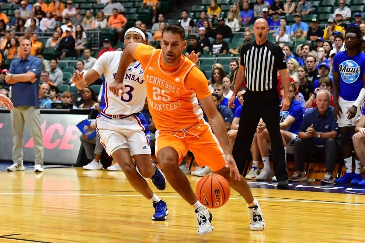 Nov 22, 2023; Honolulu, HI, USA;  Tennessee Volunteers guard Santiago Vescovi (25) drives around Kansas Jayhawks guard Dajuan Harris Jr. (3) during the first half at SimpliFi Arena at Stan Sheriff Center.