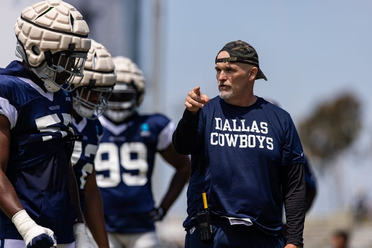 Aug 4, 2022; Oxnard, CA, USA; Dallas Cowboys defensive coordinator Dan Quinn talks to players during training camp at River Ridge Playing Fields in Oxnard, California.