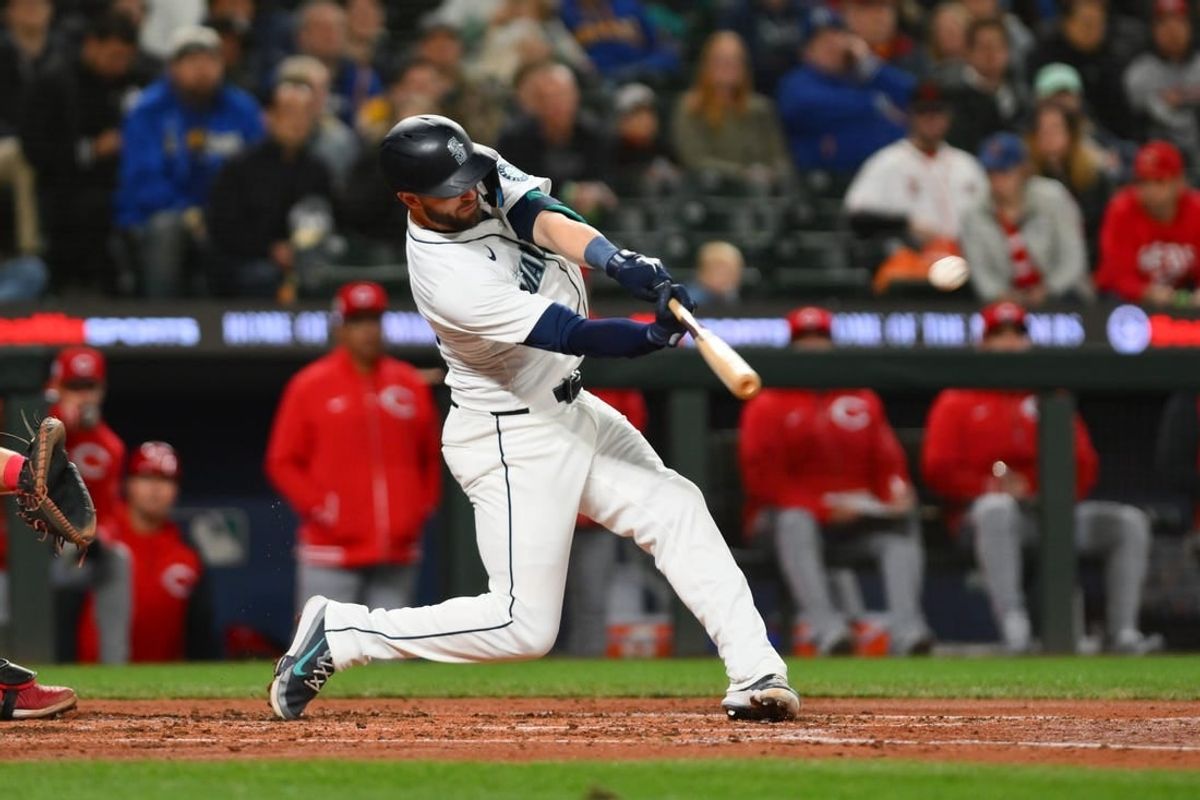 Apr 15, 2024; Seattle, Washington, USA; Seattle Mariners right fielder Mitch Haniger hits a 2-run home run against the Cincinnati Reds during the third inning at T-Mobile Park. All players wore #42 in honor of Jackie Robinson Day.