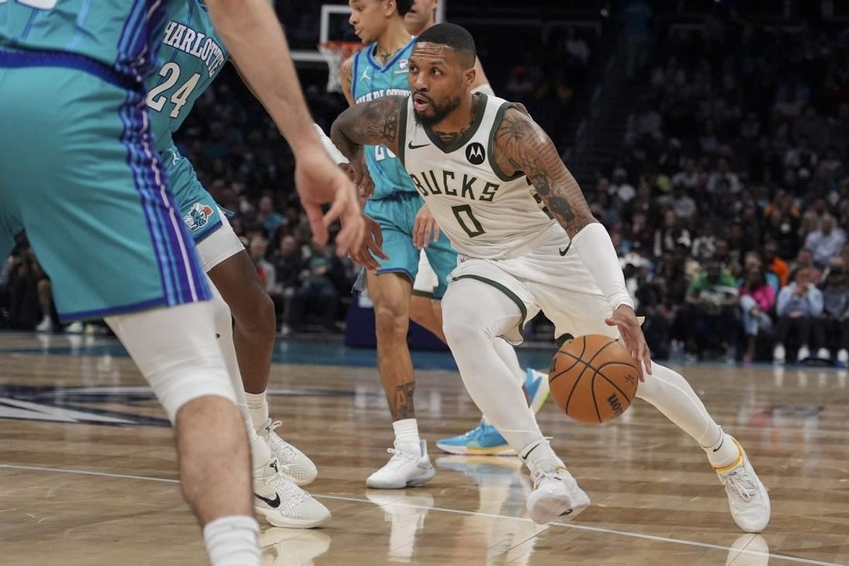Feb 29, 2024; Charlotte, North Carolina, USA; Milwaukee Bucks guard Damian Lillard (0) moves to the basket against the Charlotte Hornets during the second quarter at Spectrum Center.