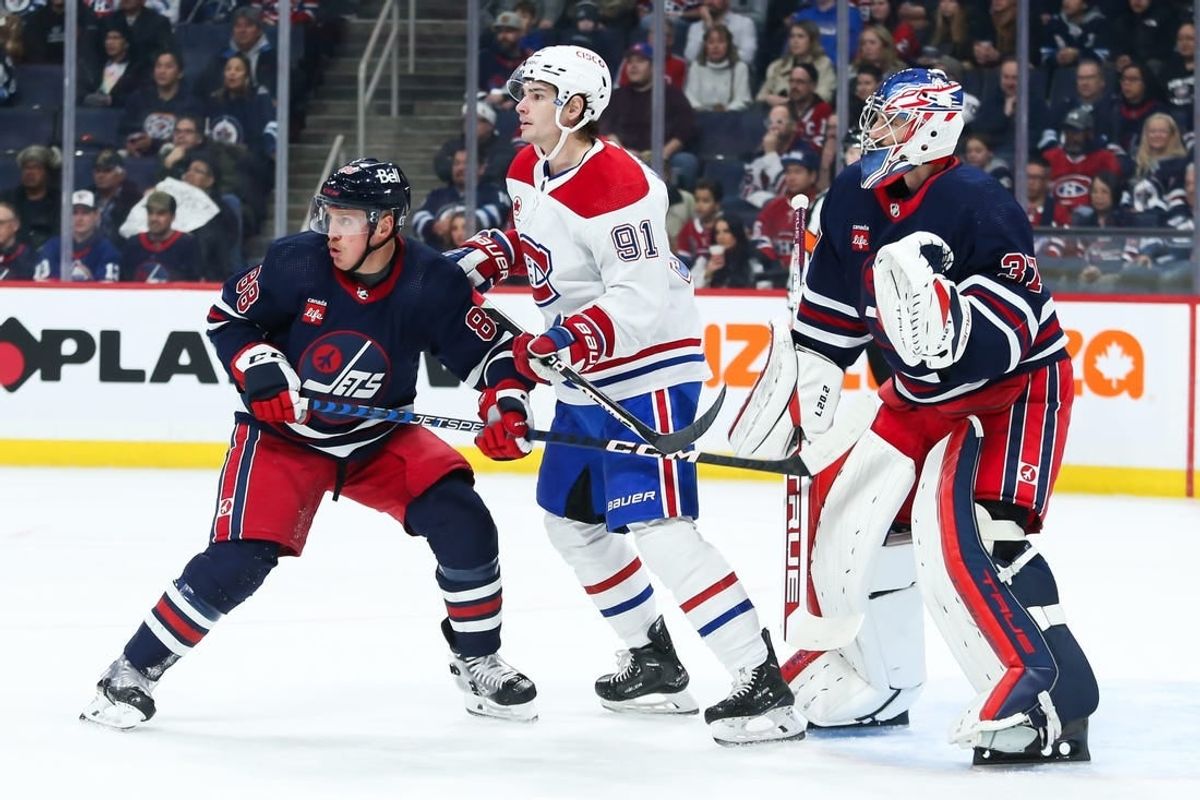 Dec 18, 2023; Winnipeg, Manitoba, CAN; Montreal Canadiens forward Sean Monohan (91) jostles for position with Winnipeg Jets defenseman Nate Schmidt (88) in front of Winnipeg Jets goalie Connor Hellebuyck (37) during the first period at Canada Life Centre.