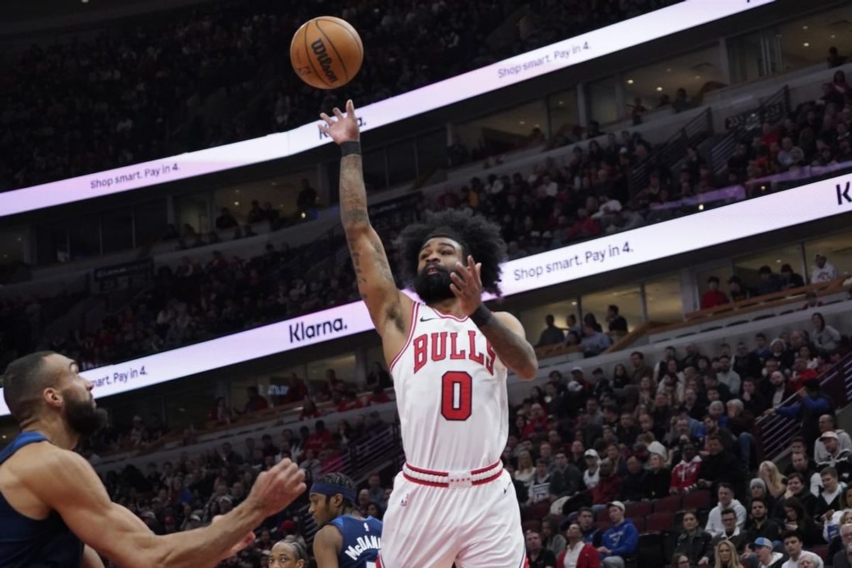 Feb 6, 2024; Chicago, Illinois, USA; Chicago Bulls guard Coby White (0) shoots over Minnesota Timberwolves center Rudy Gobert (27) during the first quarter at United Center.