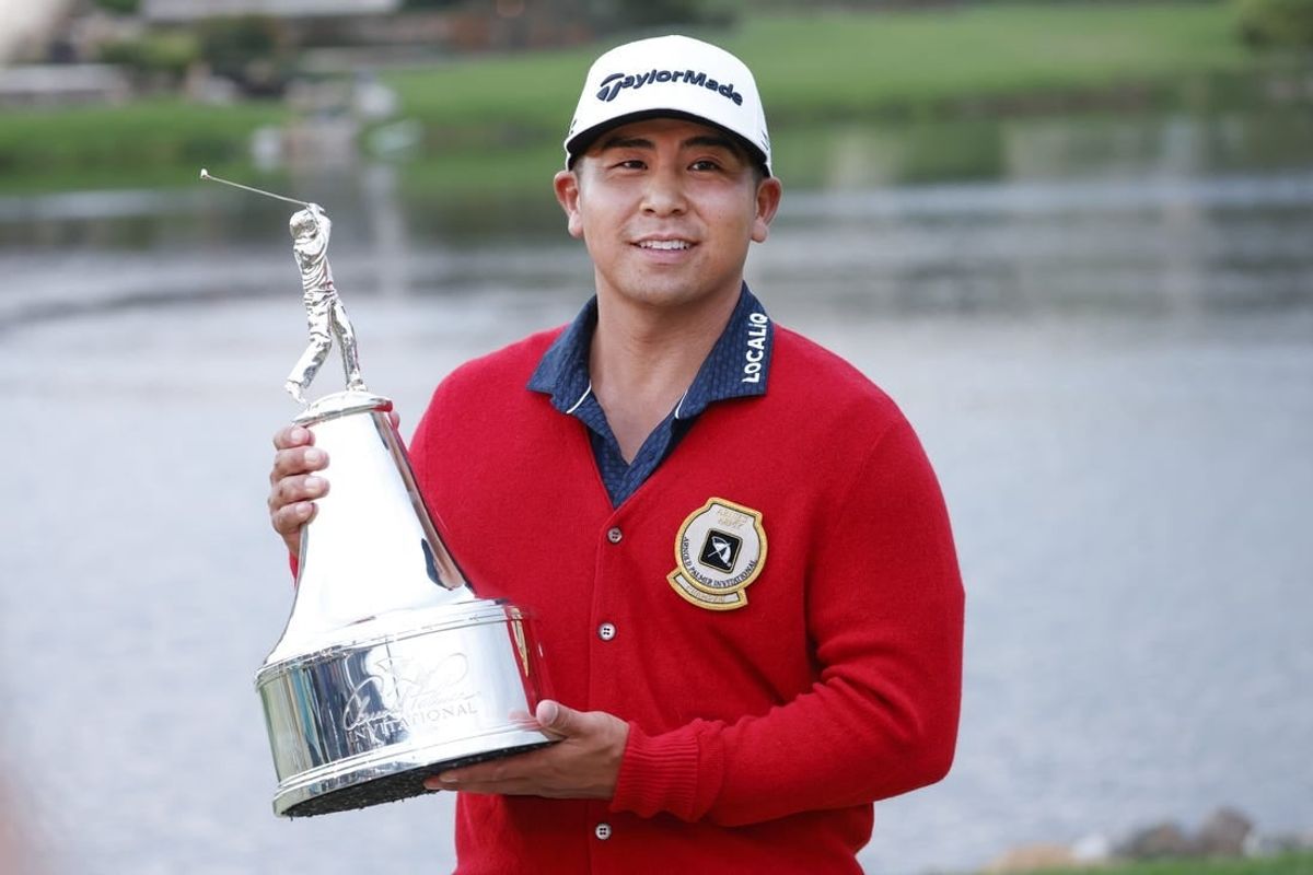 Mar 5, 2023; Orlando, Florida, USA;  Kurt Kitayama holds the champions trophy after winning the Arnold Palmer Invitational golf tournament.
