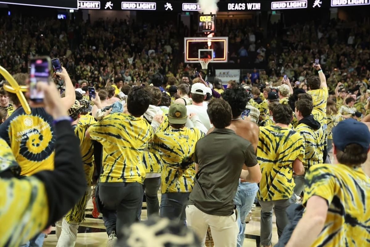 Feb 24, 2024; Winston-Salem, North Carolina, USA;  Wake Forest Demon Deacons students storm the court after Wake Forest wins at Lawrence Joel Veterans Memorial Coliseum.