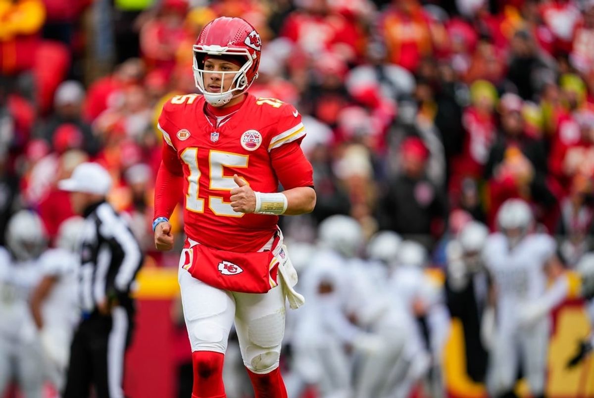 Kansas City Chiefs quarterback Patrick Mahomes (15) runs off the field after throwing an interception for a touchdown during the first half against the Las Vegas Raiders at GEHA Field at Arrowhead Stadium.