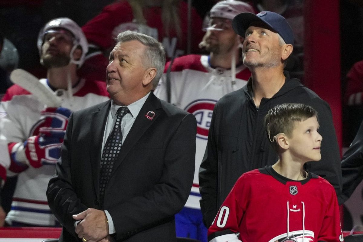 Feb 16, 2023; Raleigh, North Carolina, USA;  Carolina Hurricanes GM Don Waddell and Hurricanes owner Tom Dundon look on during the retirement of Cam Ward jersey before the game against the Montreal Canadiens at PNC Arena. Mandatory Credit: James Guillory-Imagn Images