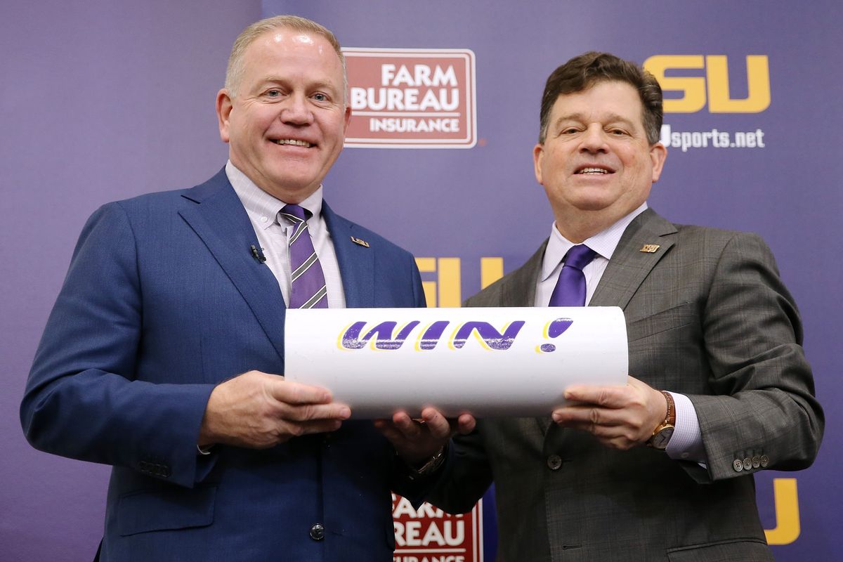 Brian Kelly, left, with LSU Athletic Director Scott Woodward.