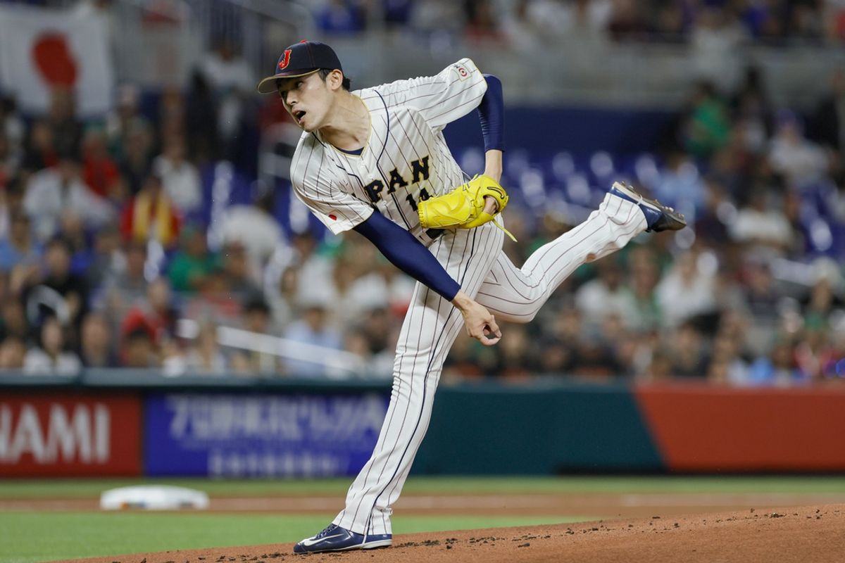 Mar 20, 2023; Miami, Florida, USA; Japan starting pitcher Roki Sasaki (14) delivers a pitch during the first inning against Mexico at LoanDepot Park. Mandatory Credit: Sam Navarro-Imagn Images