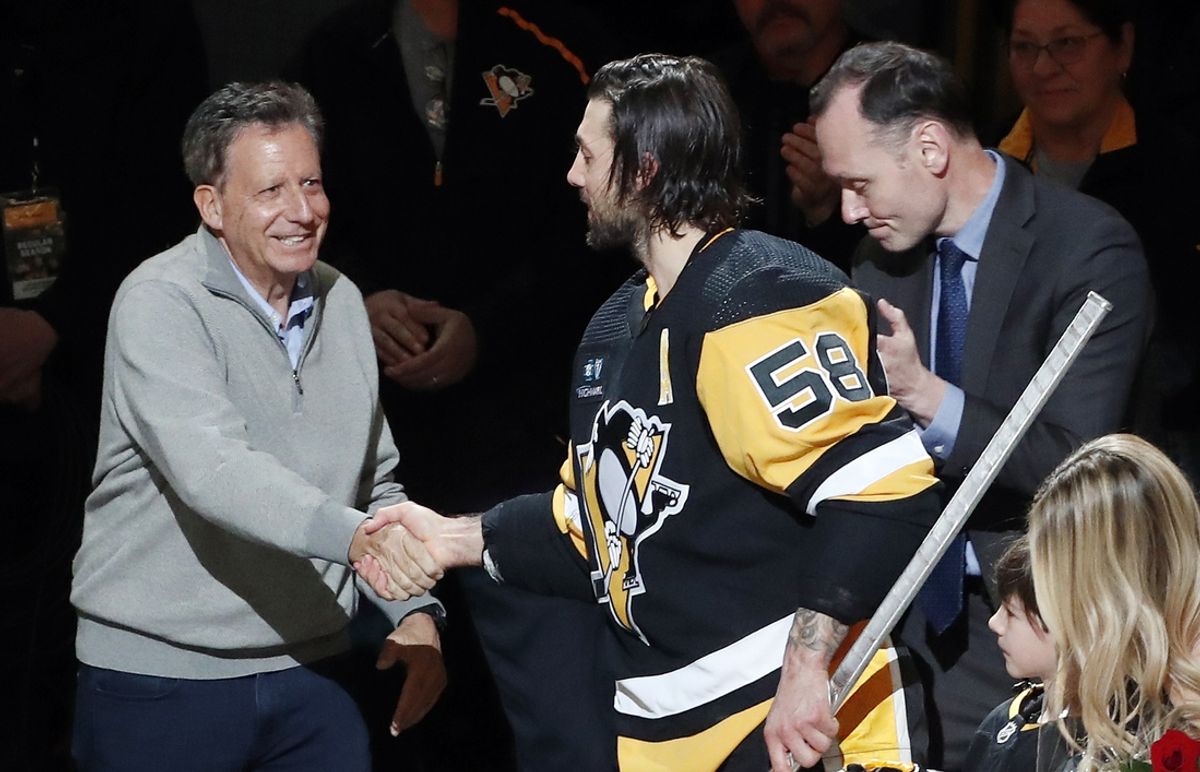 Apr 2, 2023; Pittsburgh, Pennsylvania, USA;  Fenway Sports Group chairman Tom Werner (left) and Pittsburgh Penguins president Kevin Acklin (right) congratulate defenseman Kris Letang (58) before Letang plays in his 1000th career NHL game against the Philadelphia Flyers at PPG Paints Arena. The Penguins won 4-2. Mandatory Credit: Charles LeClaire-Imagn Images