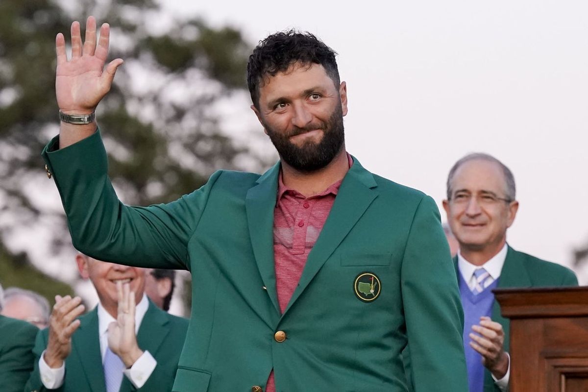 Apr 9, 2023; Augusta, Georgia, USA; Jon Rahm waves to the crowd after donning his green jacket after winning The Masters golf tournament. Mandatory Credit: Danielle Parhizkaran-USA TODAY Network