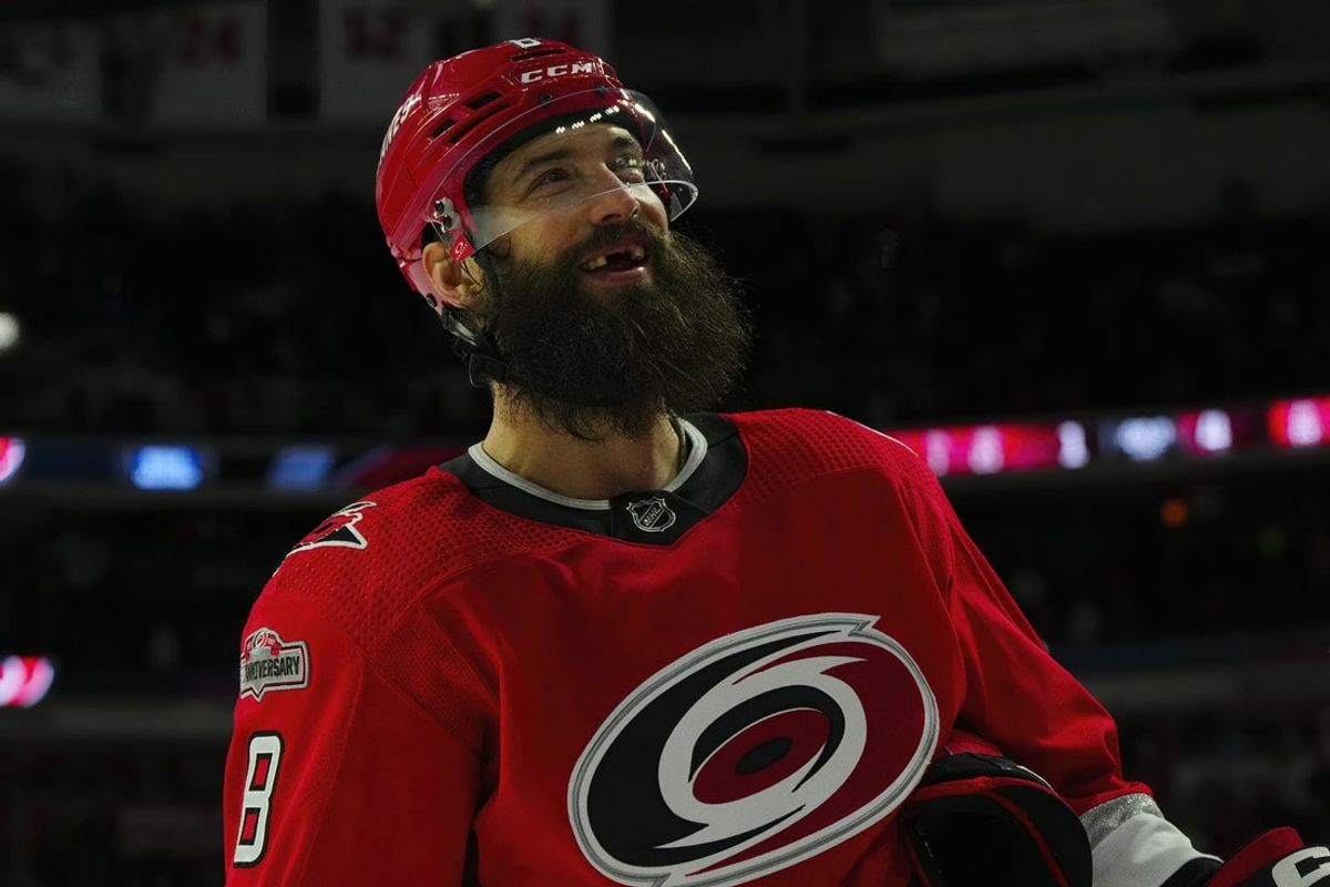 Apr 11, 2023; Raleigh, North Carolina, USA; Carolina Hurricanes defenseman Brent Burns (8) smiles up at the fans after their victory against the Detroit Red Wings at PNC Arena. Mandatory Credit: James Guillory-Imagn Images
