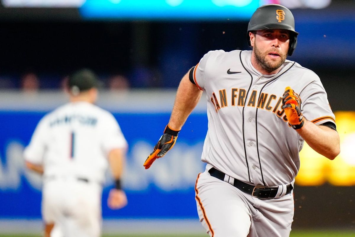 Apr 17, 2023; Miami, Florida, USA; San Francisco Giants first baseman Darin Ruf (18) rounds third base against the Miami Marlins during the third inning at loanDepot Park. Mandatory Credit: Rich Storry-Imagn Images
