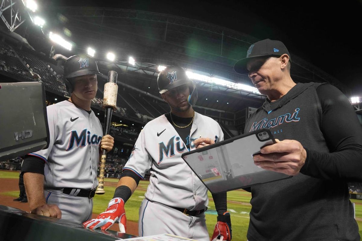 May 9, 2023; Phoenix, Arizona, USA; Miami Marlins hitting coach Brant Brown (right) talks with Miami Marlins first baseman Yuli Gurriel (middle) and Miami Marlins shortstop Joey Wendle (left) during the eighth inning of the game against the Arizona Diamondbacks at Chase Field. Mandatory Credit: Joe Camporeale-USA TODAY Sports