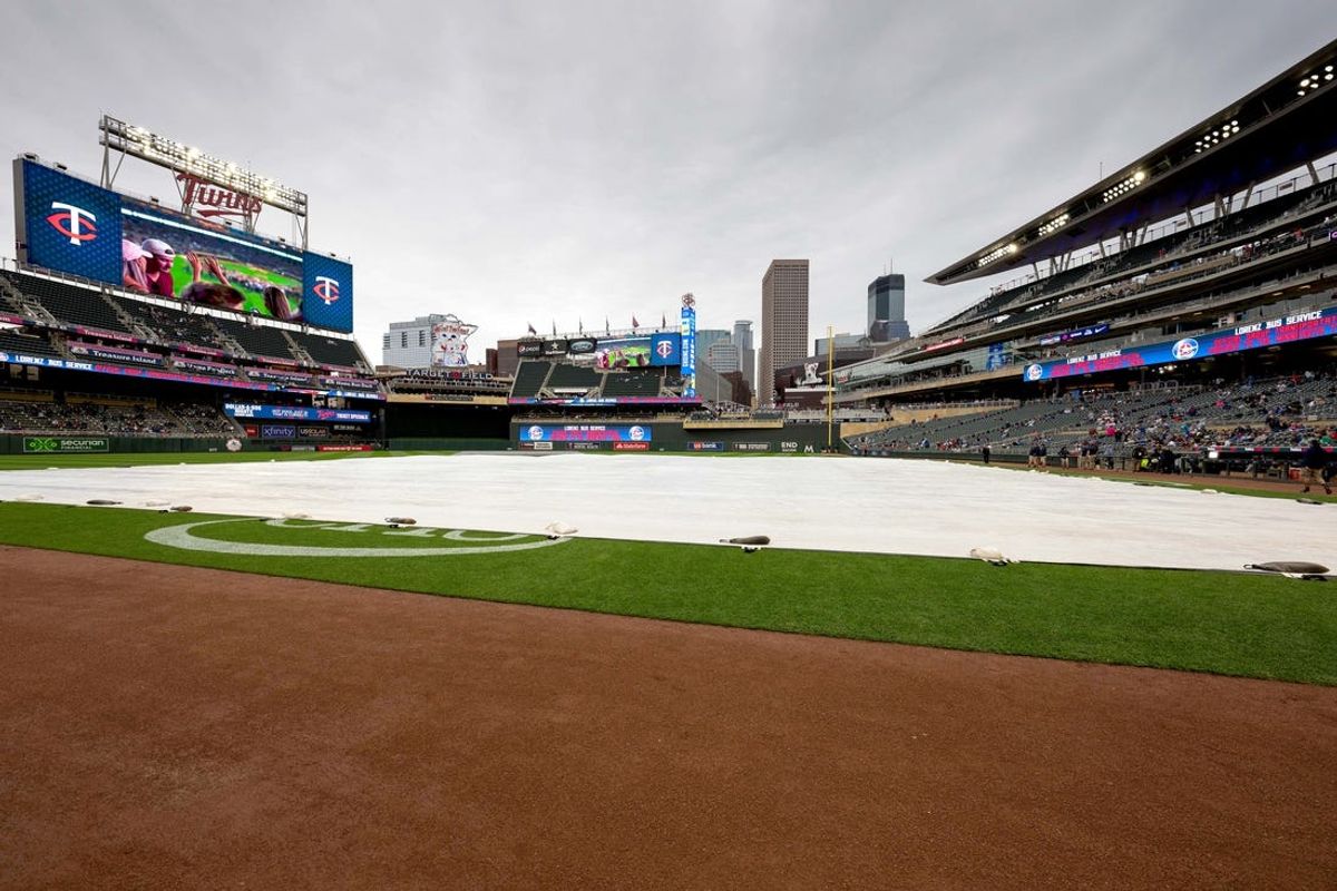May 13, 2023; Minneapolis, Minnesota, USA;  A tarp covers the infield during a rain delay before a game between the Chicago Cubs vs Minnesota Twins at Target Field. Mandatory Credit: Jordan Johnson-USA TODAY Sports