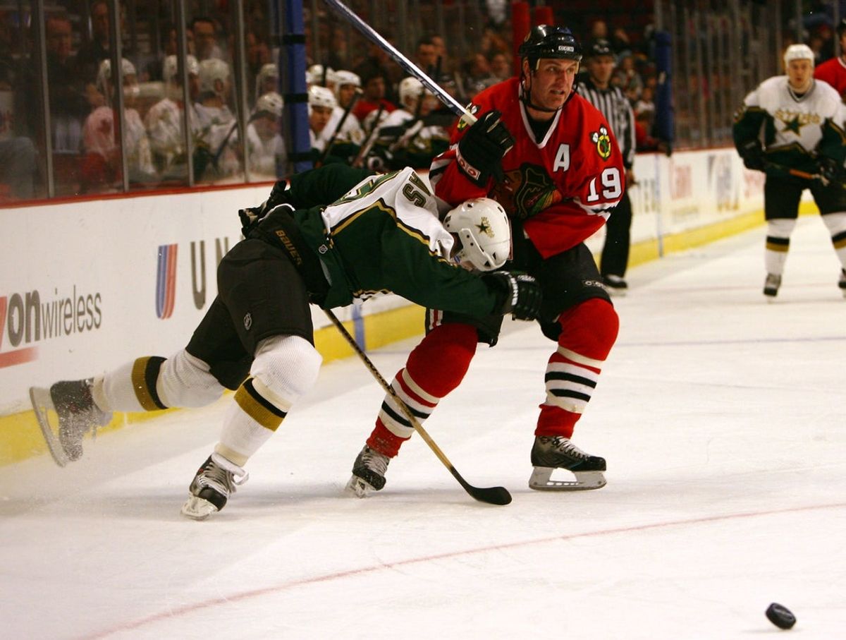 Mar 3, 2006; Chicago, IL, USA; Dallas Stars defenseman Stephane Robidas (3) crashes into Chicago Blackhawks left wing Kyle Calder (19) while chasing the puck during the third period at the United Center in Chicago, IL.  The Dallas Stars defeated the Chicago Blackhawks 7-2.  Mandatory Credit: Jerry Lai-Imagn Images © Copyright 2006 Jerry Lai
