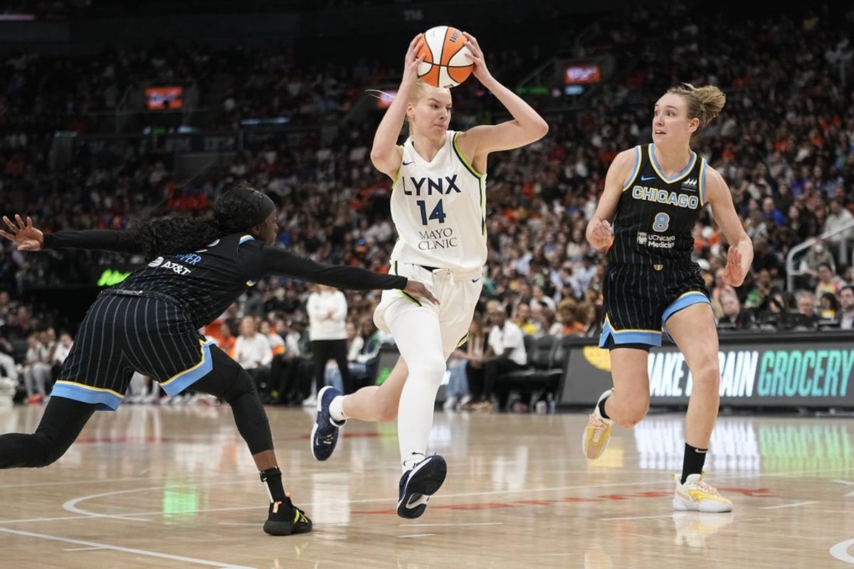 May 13, 2023; Toronto, Ontario, Canada; Minnesota Lynx forward Dorka Juhasz (14) drives past Chicago Sky guard Kahleah Copper (2) and forward Alanna Smith (8) during the second half at Scotiabank Arena. Mandatory Credit: John E. Sokolowski-Imagn Images