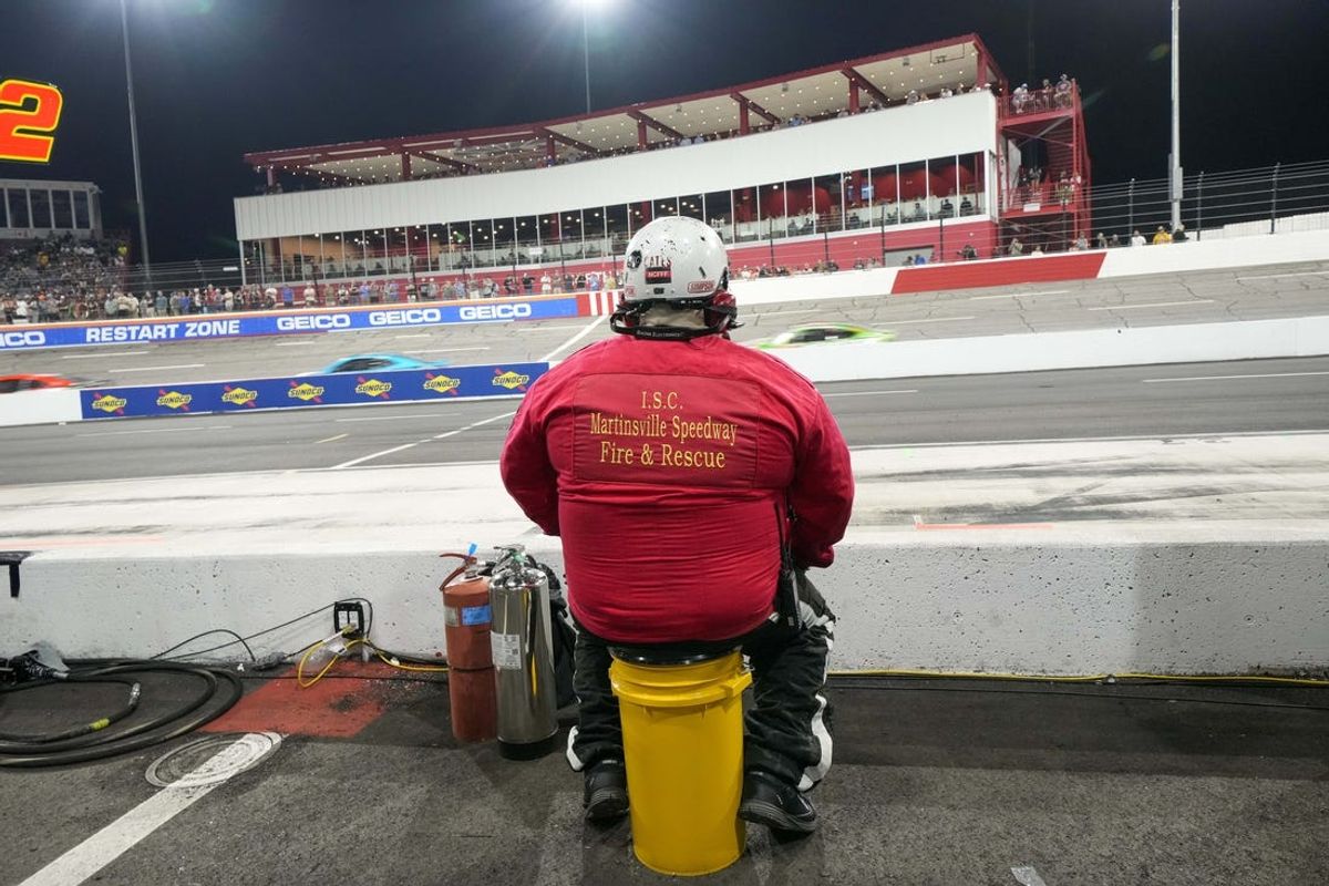 May 21, 2023; North Wilkesboro, North Carolina, USA;  A track worker mans his post during the All Star Race at North Wilkesboro Speedway. Mandatory Credit: Jim Dedmon-USA TODAY Sports