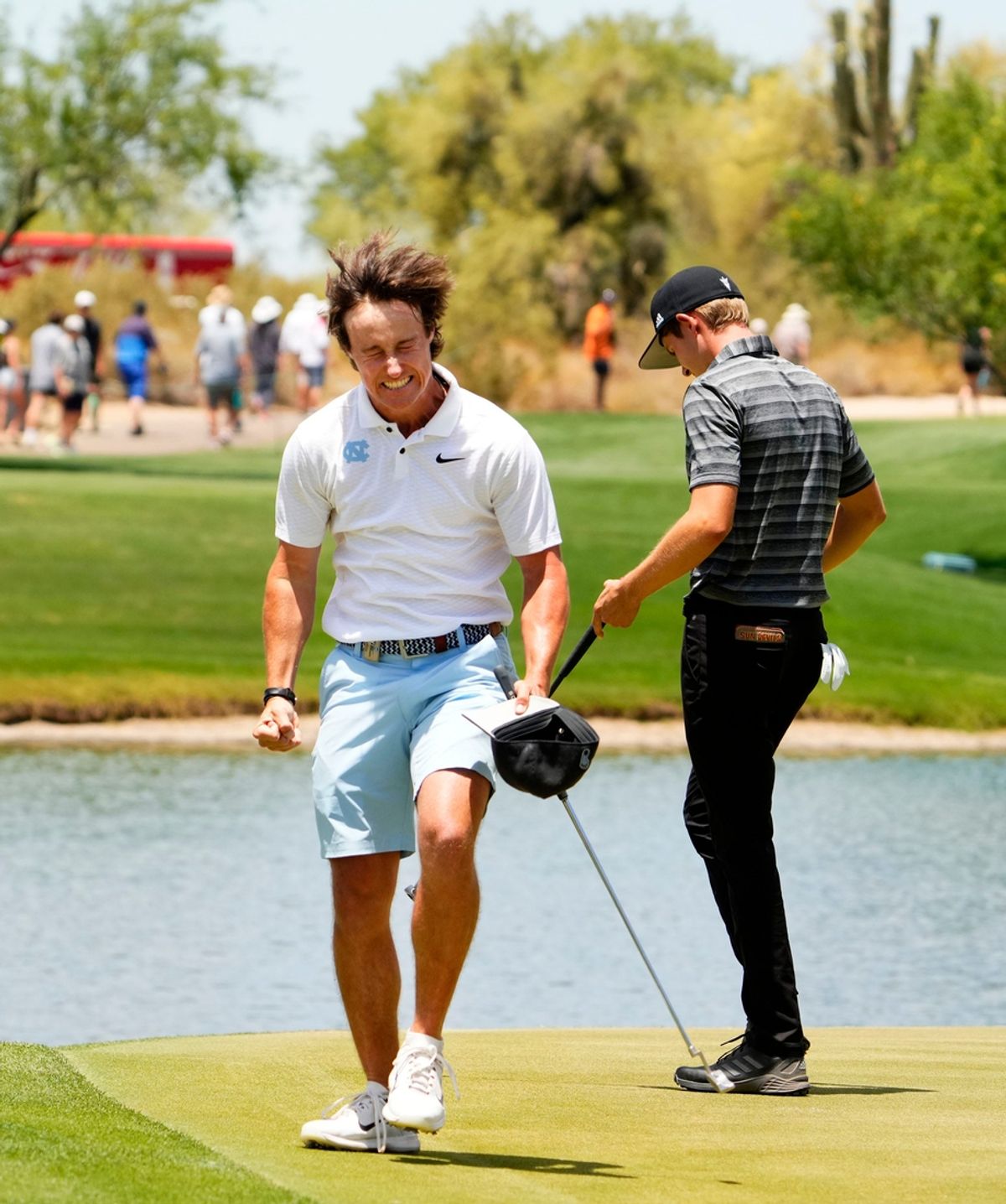 North Carolina golfer David Ford reacts after defeating Arizona State golfer Michael Mjaaseth (right) 1UP on the 18th hole during NCAA Championship match play quarterfinals at Grayhawk Golf Club in Scottsdale on May 30, 2023.
