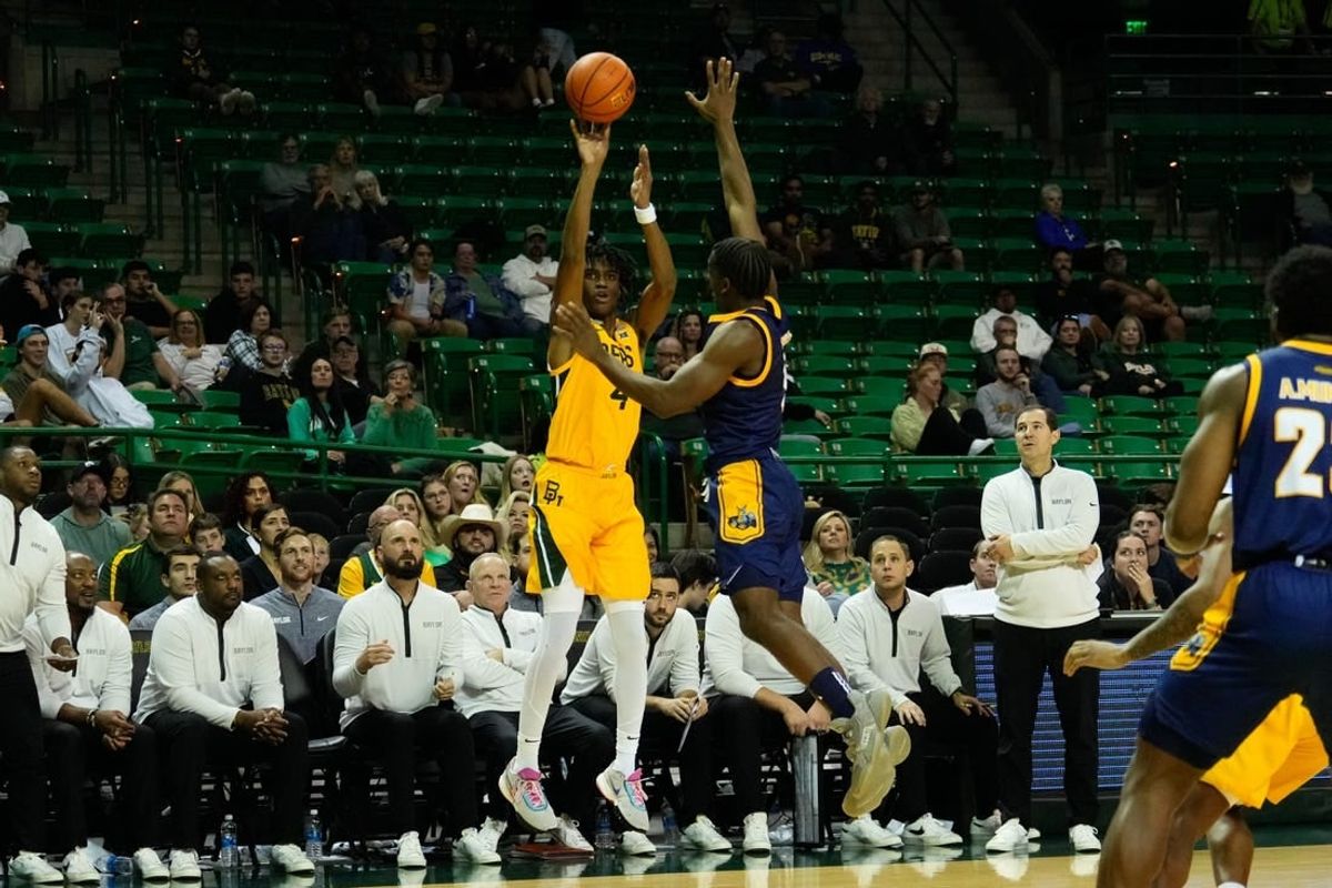 Nov 14, 2023; Waco, Texas, USA; Baylor Bears guard Ja'Kobe Walter (4) makes a three point shot against UMKC Kangaroos guard Jayson Petty (1) during the second half at Ferrell Center.