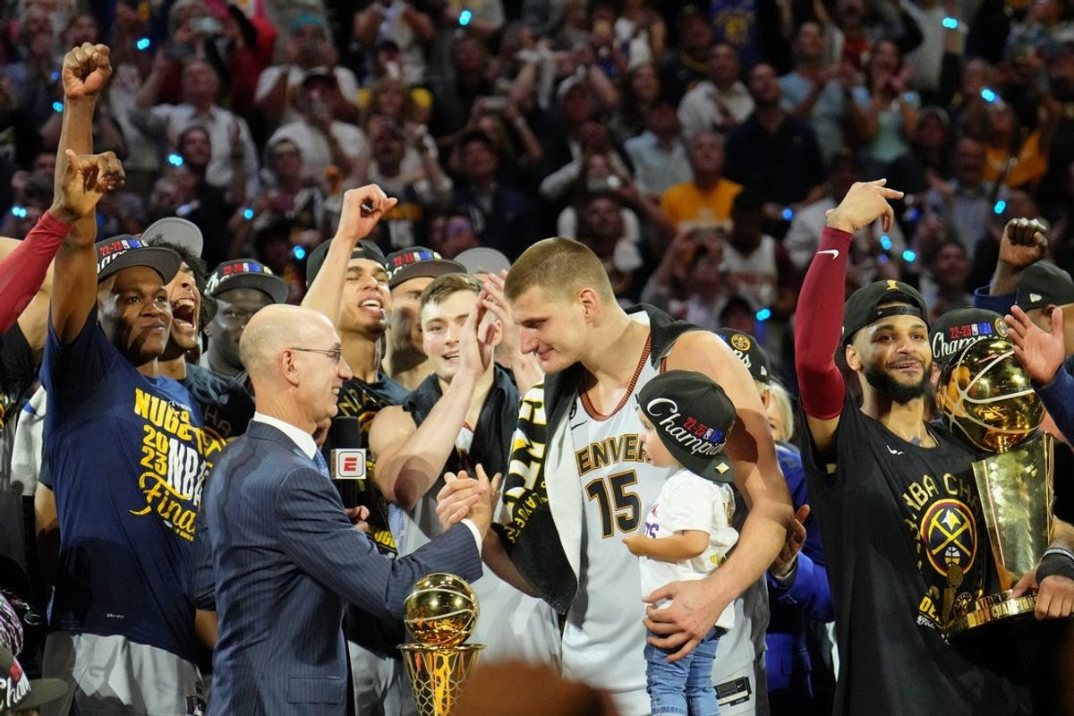 Jun 12, 2023; Denver, Colorado, USA; NBA commissioner Adam Silver presents Denver Nuggets center Nikola Jokic (15) the Bill Russell NBA Finals MVP Award after winning the 2023 NBA Finals against the Miami Heat at Ball Arena. Mandatory Credit: Kyle Terada-USA TODAY Sports