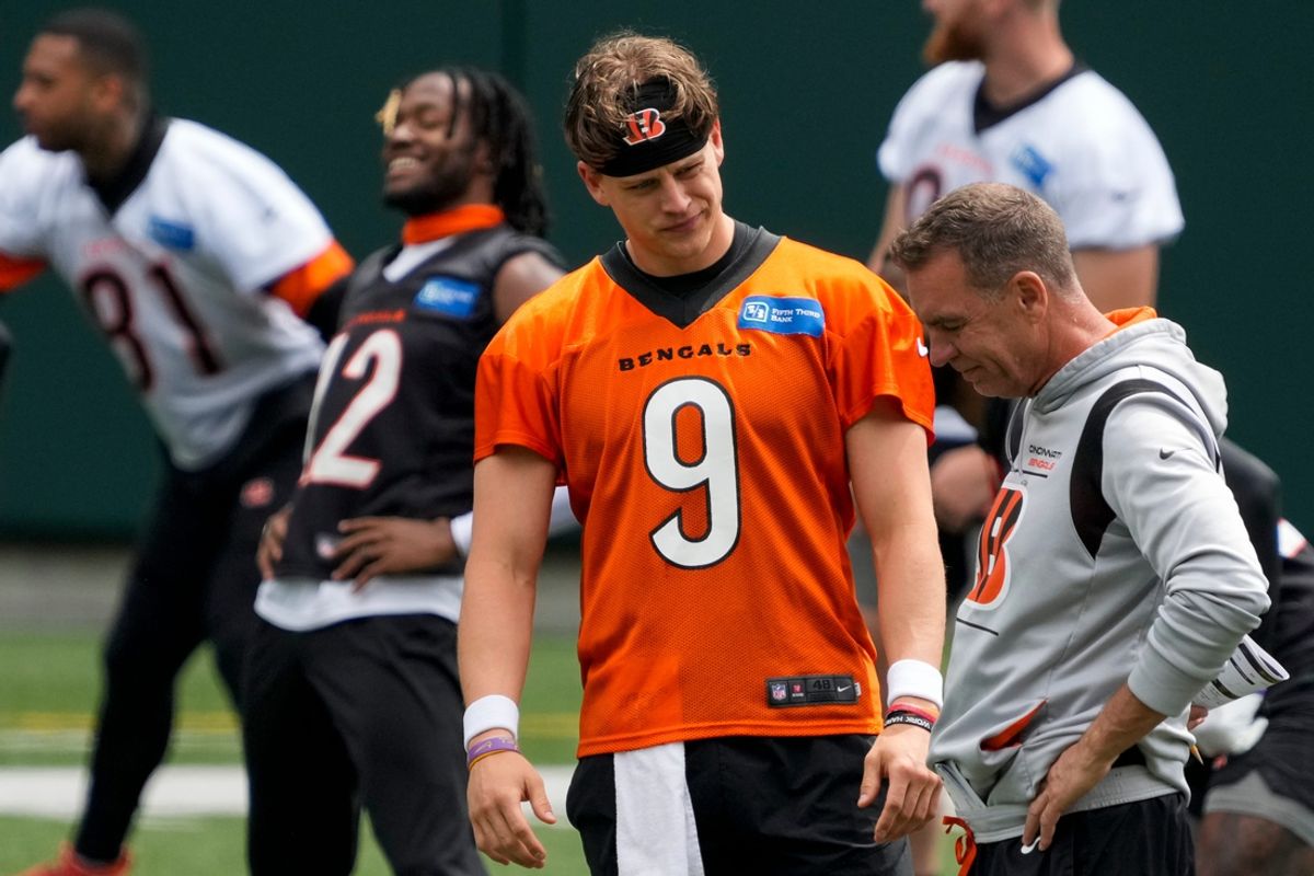 Cincinnati Bengals quarterback Joe Burrow (9) talks with defensive coordinator Lou Anarumo during an off-season workout inside Paycor Stadium in downtown Cincinnati on Wednesday, June 14, 2023.