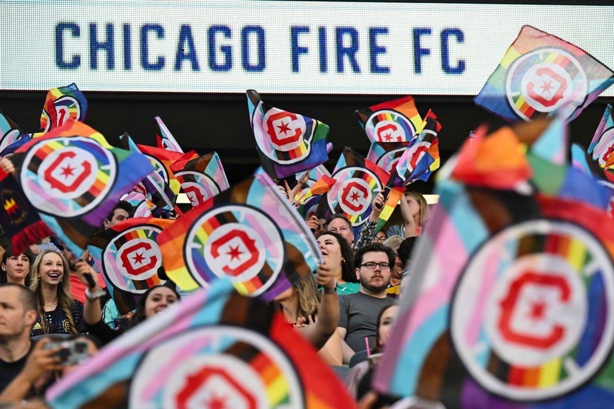 June 10, 2023; Chicago, Illinois, USA;  Fans wave Pride flags before a match between the Chicago Fire FC and the Columbus Crew SC at Soldier Field. Mandatory Credit: Jamie Sabau-Imagn Images