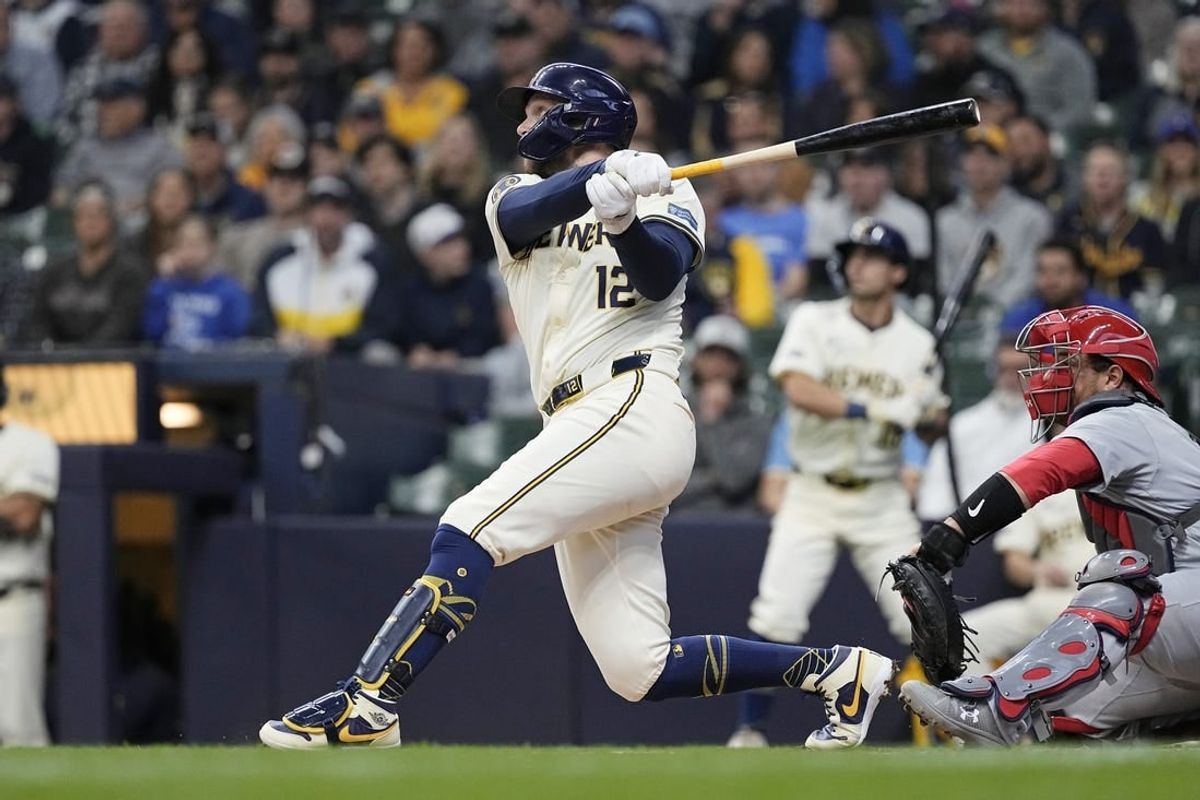 May 9, 2024; Milwaukee, Wisconsin, USA;  Milwaukee Brewers first baseman Rhys Hoskins (12) hits a home run during the first inning against the St. Louis Cardinals at American Family Field.