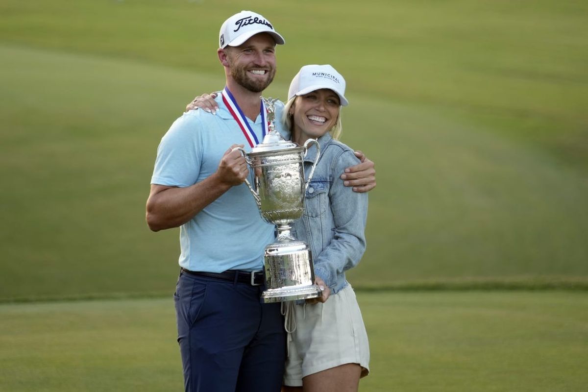 Jun 18, 2023; Los Angeles, California, USA; Wyndham Clark poses with the championship trophy and his girlfriend Julia Kemming after winning the U.S. Open golf tournament at Los Angeles Country Club. Mandatory Credit: Michael Madrid-USA TODAY Sports