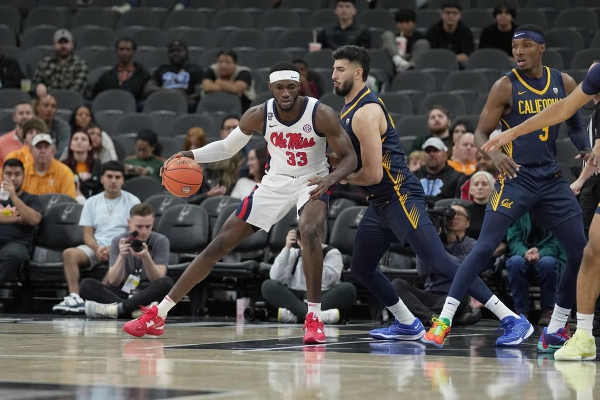 Dec 16, 2023; San Antonio, Texas, USA;  Mississippi Rebels forward Moussa Cisse (33) is defended by California Golden Bears forward Fardaws Aimaq in the first half at the Frost Bank Center.