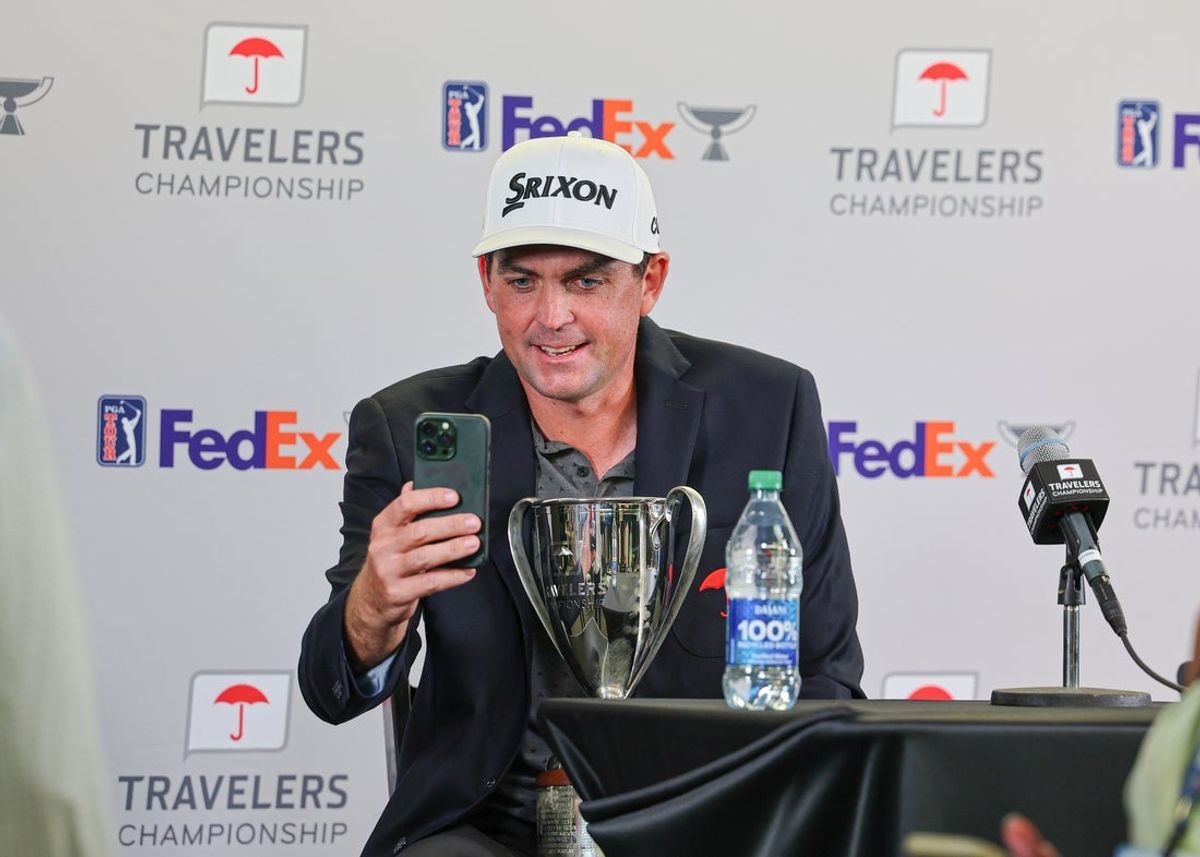Jun 25, 2023; Cromwell, Connecticut, USA; Keegan Bradley addresses social media on a smart phone after winning the Travelers Championship golf tournament. Mandatory Credit: Vincent Carchietta-Imagn Images