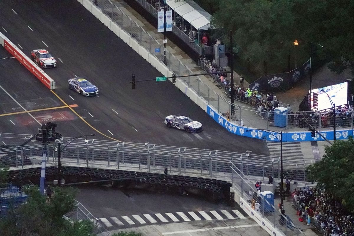 Jul 2, 2023; Chicago, Illinois, USA; NASCAR Cup Series driver Shane Van Gisbergen (91) leads the field in turn one on the final lap on his way to win the Grant Park 220 of the Chicago Street Race viewed from the NEMA Chicago buliding. Mandatory Credit: Jon Durr-Imagn Images