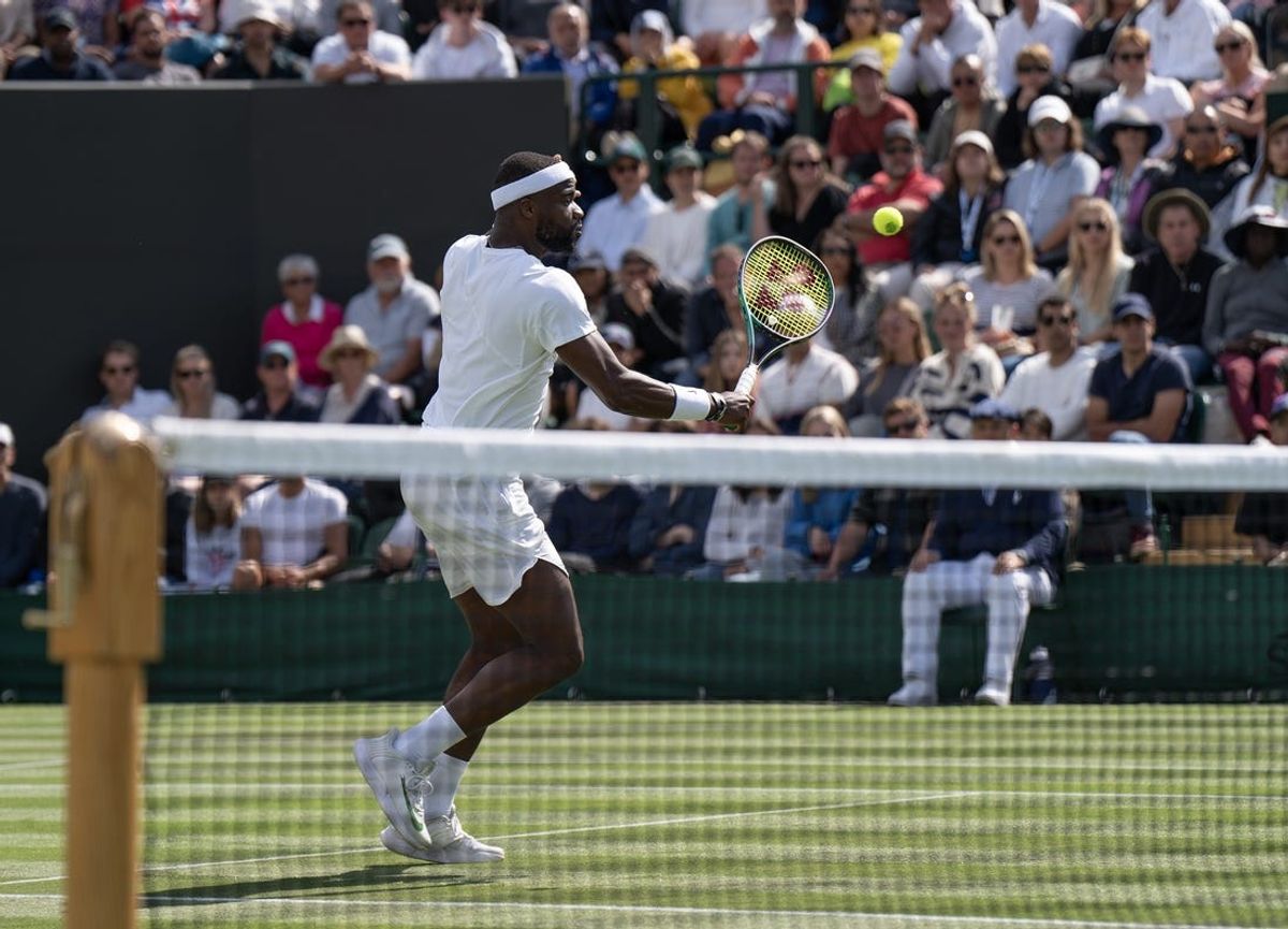 Jul 5, 2023; London, United Kingdom; Frances Tiafoe (USA) returns a shot during his match against Yibing Wu (CHN) on day three of Wimbledon at the All England Lawn Tennis and Croquet Club.  Mandatory Credit: Susan Mullane-USA TODAY Sports