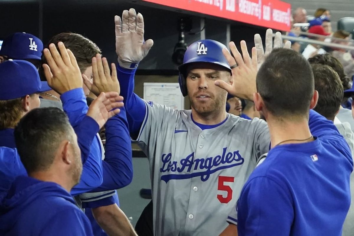 Apr 28, 2024; Toronto, Ontario, CAN; Los Angeles Dodgers first baseman Freddie Freeman (5) celebrates with teammates after hitting a solo home run against the Toronto Blue Jays during the sixth inning at Rogers Centre.