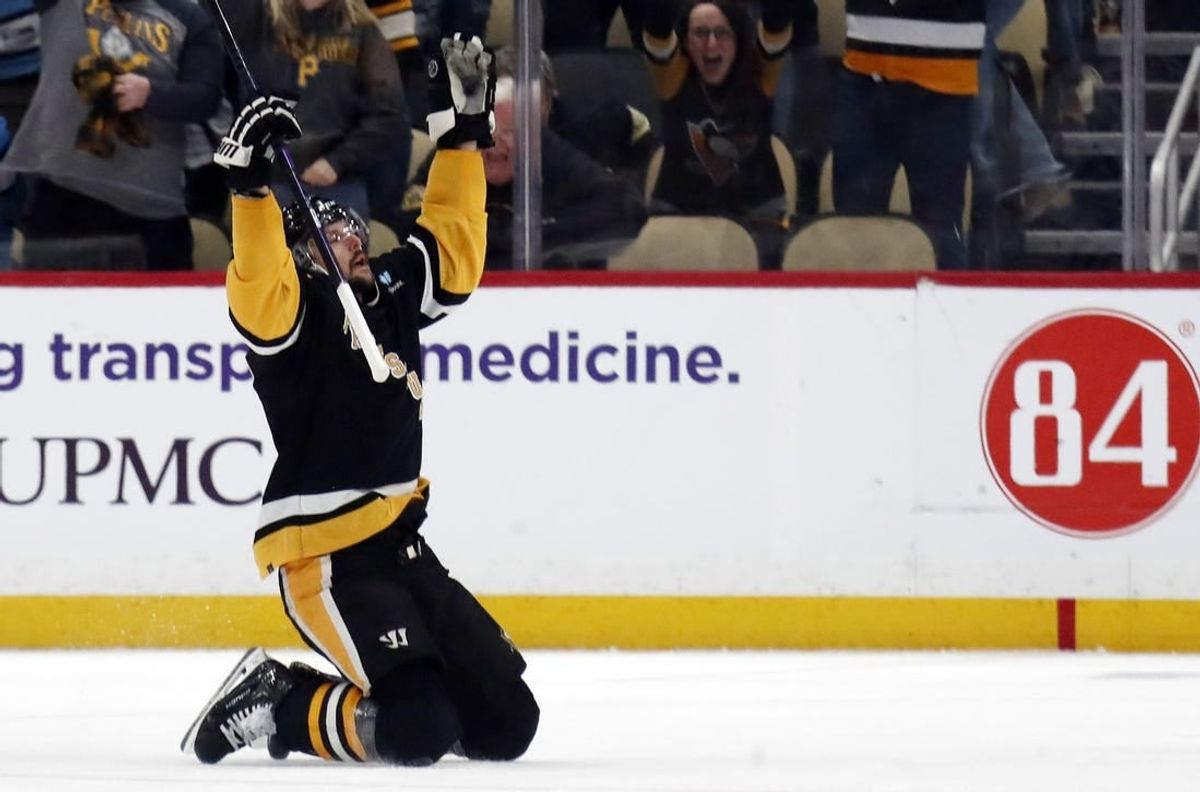 Apr 11, 2024; Pittsburgh, Pennsylvania, USA; Pittsburgh Penguins defenseman Erik Karlsson (65) reacts after scoring the game winning goal against the Detroit Red Wings in overtime at PPG Paints Arena. Pittsburgh won 6-5 in overtime.