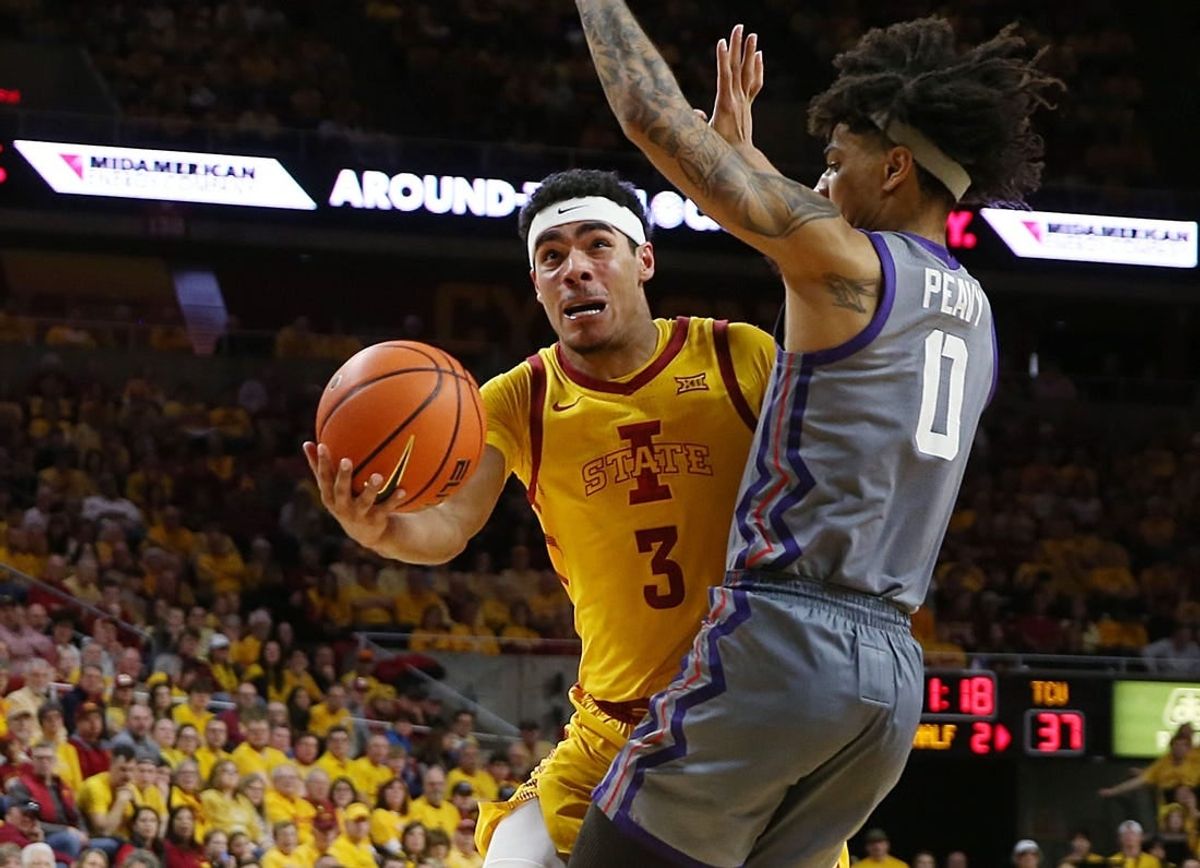 Iowa State Cyclones guard Tamin Lipsey (3) lays up the ball around TCU Horned Frogs guard Micah Peavy (0) during the second half in the Big-12 conference showdown of a NCAA college basketball at Hilton Coliseum on Saturday, Feb. 10, 2024, in Ames, Iowa.