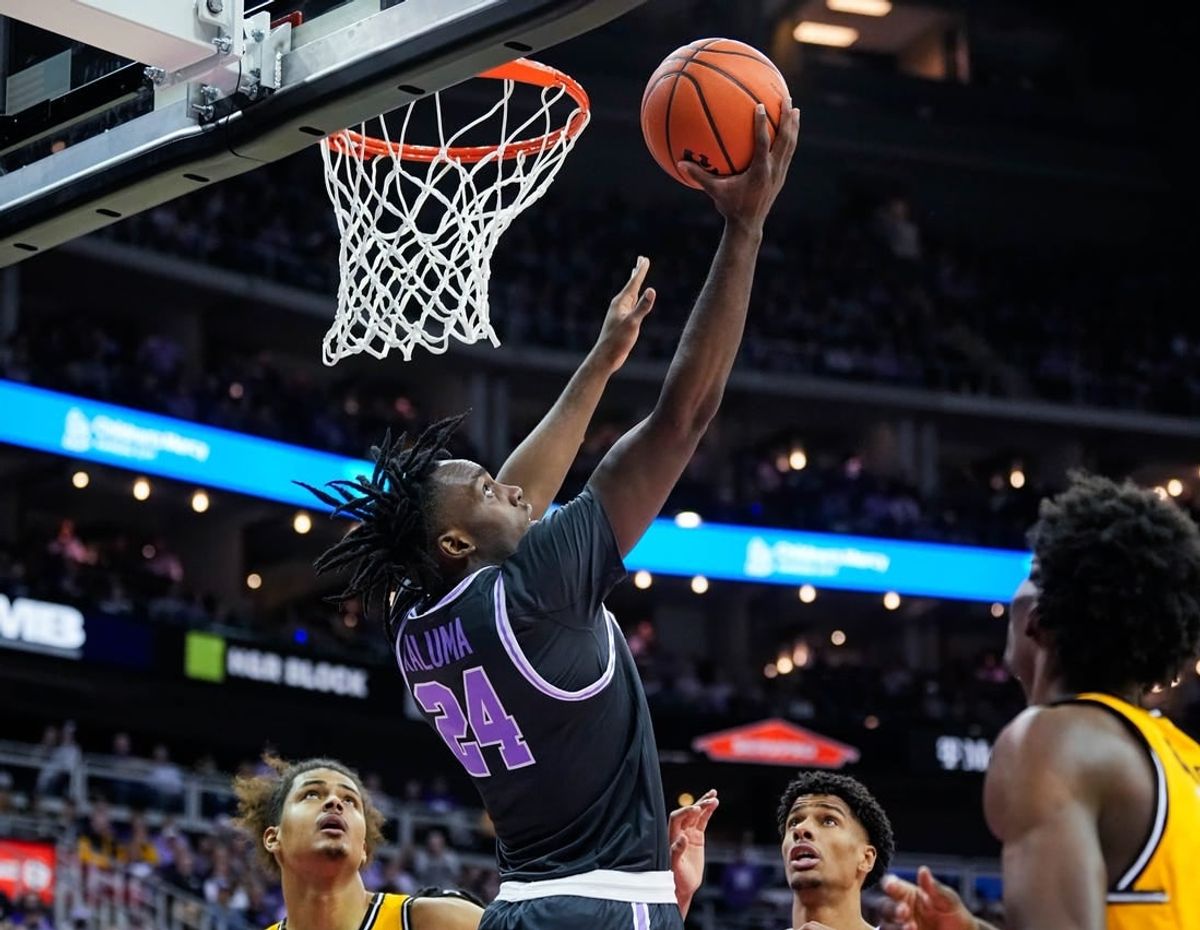 Dec 21, 2023; Kansas City, Missouri, USA; Kansas State Wildcats forward Arthur Kaluma (24) shoots against Wichita State Shockers forward Kenny Pohto (11) during the first half at T-Mobile Center.